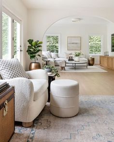 a living room filled with furniture and lots of windows