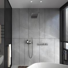 a bathroom with a bathtub, shower head and towel rack on the wall next to it