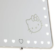 a hello kitty light up mirror with hearts on the bottom and an image of a cat's face