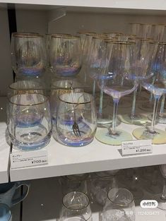 there are many wine glasses on the shelf