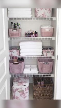 an organized closet with baskets and towels