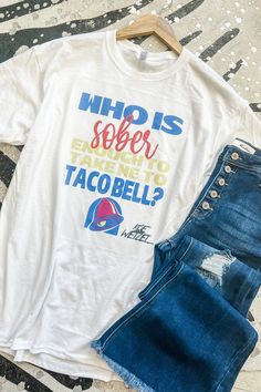 Can someone please take us to taco bell??? This fun graphic tee pairs well with late night bad decisions & cinnamon twists! ;) unisex fit crew neck 50% cotton, 50% polyester Southern Roots Boutique112 W Main St. Paragould, AR *Please allow 5-7 business days processing time for this item to be shipped/picked up. Game Day Graphic Tee With Funny Print, Casual T-shirt With Funny Text For Game Day, Taco Bell Shirt, Cinnamon Twists, Bad Decisions, Taco Bell, Cool Graphic Tees, Late Night, Graphic Tee