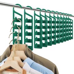 green clothes hangers are hanging on a rail