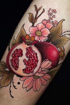 a pomegranate with flowers and leaves on the arm is shown in color