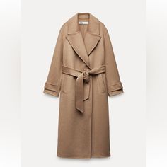 Long Double Faced Coat Made With 50% Wool Blend Fabric. Lapel Collar And Long Sleeves With Belted Cuffs. Tied Self Belt. Flap Pockets At Front. Side Vents At Hem. Dark Camel Outer Shell 50% Wool 43% Polyester 7% Other Fibres Elegant Brown Wool Coat For Spring, Elegant Zara Outerwear For Fall, Luxury Zara Outerwear For Spring, Luxury Spring Outerwear By Zara, Zara Luxury Spring Outerwear, Elegant Belted Zara Outerwear, Zara Elegant Belted Outerwear, Luxury Zara Outerwear For Work, Zara Winter Coat