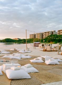 many pillows are laid out on the beach