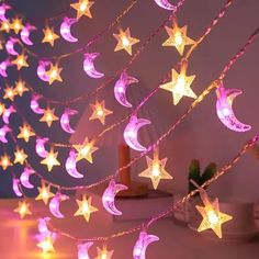 stars and moon string lights are hanging from the ceiling