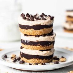 three layered desserts stacked on top of each other with chocolate chips around the edges