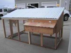 a chicken coop in the middle of a parking lot