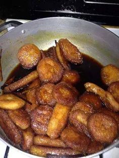 some fried bananas are in a pan on the stove