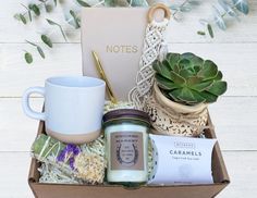 This gift includes a cozy stoneware mug, soy candle, sea salt caramels, beautiful plant, notebook with pen and macrame bookmark and an herb bundle. Perfect Fall gift for friends, co-workers, birthdays, new home, thank you's and so much more... ➡️ Includes: 1.  Stoneware modern mug. 14 oz. 2. Soy Candle in 8oz Glass Mason Jar. Choose your scent. 3. Succulent in Ceramic Vessel. 4-inch. Care instructions. 4. McCrea's Cape Cod Sea Salt Caramels (5 pack.) 5. Notebook, Pen & Macrame Bookmark. 5 x 7 co Notebook Bookmark, Plant Candle, Macrame Bookmark, Sea Salt Caramels, Plant Notebook, Ocean Scent, Aromatherapy Gift Set, Modern Mugs, Eucalyptus Mint