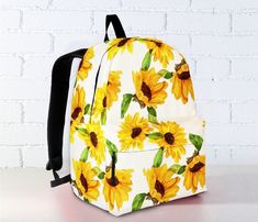 "Are you a Sunflower Lover? These Backpack are perfect for you or your kids. Looking for a unique and special gift for a Sunflower Lover. These Backpack are exactly what you are looking for. Product Features: - Backpack Size (Height x Length x Width): + Child (Age 4-7): 12\"(30cm) x 9\"(22.5cm) x 5\"(12.5cm). + Youth (Age 8-12): 16\"(40cm) x 12\"(30cm) x 7\"(17.5cm). + Adult (Age 14 18\"(45cm) x 14\"(35cm) x 8\"(20cm). - Features ergonomic shoulder straps with dynamic size adjustment for the per Cute Yellow Backpack For Back To School, Cute White Summer Backpack, Casual Floral Print Backpack, White Floral Print School Bag, Trendy White Backpack As Gift, Trendy White Backpack For Gift, Yellow Summer School Backpack, Yellow Backpack For School In Summer, Casual White Backpack For Gift