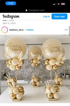 some balloons are sitting on top of a table with gold foil balls in the shape of flowers