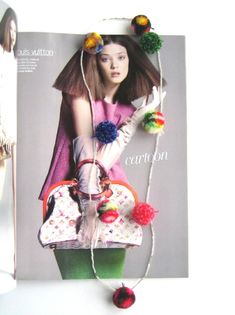 a magazine with an image of a woman holding a purse and pom poms