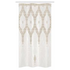 a white shower curtain with an intricate design on it's side and gold trim