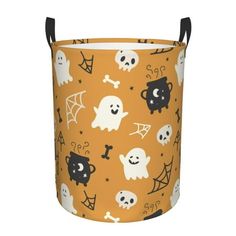 an orange halloween bucket with black handles and white skulls, ghostes and bats on it