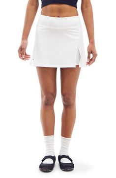 Work out or chill out in this stretchy skort designed with an airy side vent. 13 1/2" length; 4" inseam; 16 "leg opening (size Medium) Elastic waist Side vent 90% polyester, 10% spandex Machine wash, line dry Imported White Summer Bottoms With Elastic Side Panels, White Fitted Bottoms With 5-inch Inseam, Fitted Tennis Bottoms With Elastic Waistband, Stretch Bottoms With Elastic Waistband For Tennis, Elastic Stretch Bottoms For Tennis, Solid Color Tennis Shorts, Stretch Summer Tennis Bottoms, Stretch Tennis Bottoms With Built-in Shorts, Casual Stretch Tennis Shorts