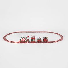 a red and white train with santas riding on it