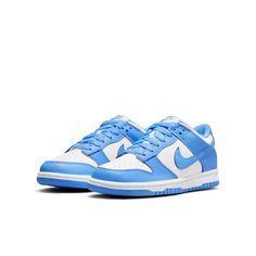 The Nike Dunk Low GS 'University Blue' is a sneaker that pays homage to its collegiate hardwood roots. This low-top shoe features a leather upper in a color-blocked design, with a crisp white base and pastel blue finish on the eyestay, Swoosh, and heel and forefoot overlays. Nike branding is featured on the tongue tag and heel tag, while the shoe sits on a durable rubber cupsole. The outsole provides performance-ready traction, making this sneaker perfect for big kids who want a stylish and functional sneaker. Nike Azul, Unc University, Customized Shoes, Trendy Shoes Sneakers, Blue Jordans, Fresh Sneakers, Nike Models, Cute Nike Shoes, Cute Nikes