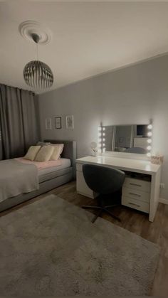 a bedroom with a bed, desk and mirror