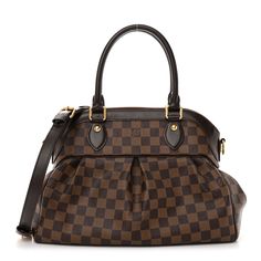 This is an authentic LOUIS VUITTON Damier Ebene Trevi PM. This is a very stylish handbag that is beautifully crafted of signature Louis Vuitton Damier coated canvas in brown. The bag features polished brass hardware, chocolate brown cowhide leather trim, rolled leather top handles, and an optional adjustable shoulder strap. The top zipper opens the bag to a cherry red microfiber interior with patch pockets. Brown Cowhide, Louis Vuitton Empreinte, Louis Vuitton Vernis, Embroidered Monogram, Louis Vuitton Damier Ebene, Damier Ebene, Louis Vuitton Shoulder Bag, Cherry Red, Brass Hardware