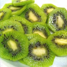 sliced kiwi fruit on a white plate