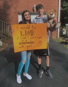 two people holding up a sign that says i would be lion if i said it didn't