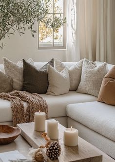 a living room filled with lots of furniture and candles on top of a coffee table