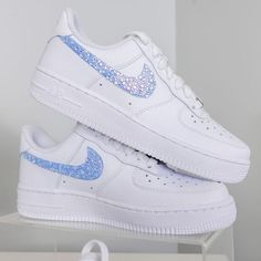 Sneakers by Nike. Designs by DJ ZO Designs Iridescent blue rhinestones on swooshes are hand-glued one-by-one The beauty of iridescence is that the crystals can look a little different in different lighting! SIZE & FIT Nike Air Force 1 fit true to size Nike Women's Shoe Size Chart Nike Rosa, Quinceanera Shoes, Nike Kids Shoes, Casual Shoes Women Sneakers, Nike Shoes Women Fashion, Custom Sneakers Diy, Pretty Sneakers, Shoe Size Chart Kids, Pretty Shoes Sneakers