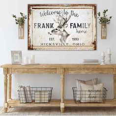 a wooden table topped with baskets under a framed deer sign next to a white wall