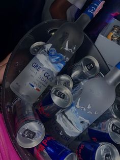 several bottles and cans in a plastic container