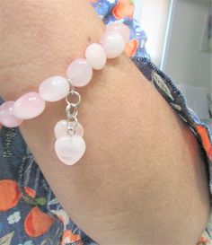 A Soothing and Comforting Stretch Bracelet to wear every time !  Rose Quartz  the Universal Stone of Love in a pretty bracelet with hearts Rose quartz charms.   measures:   7 - 7.1/2  inches.  (Expands to fit larger hands and wrists)  Each nugget is approx. 1/2 inch.  Pretty, romantic gift for that special lady. Pink Natural Stones Jewelry For Friendship, Pink Spiritual Charm Bracelet For Friendship, Pink Natural Stone Bracelets For Friendship, Pink Natural Stones Bracelet For Friendship, Rose Quartz Bracelets As Valentine's Day Gift, Rose Quartz Bracelets For Valentine's Day Gift, Adjustable Heart-shaped Pink Crystal Bracelet, Rose Quartz Friendship Bracelet, Pink Spiritual Bracelets For Valentine's Day