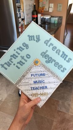 someone is holding up a graduation cap that says, my dreams come to life future music teacher