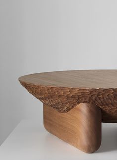 a wooden table sitting on top of a white surface