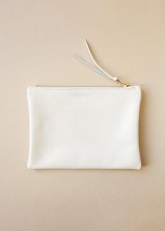 Pearl Ivory classic clutch purse with a wonderful gold tone brass zip. This little purse make a perfect gift for your best friend or someone from your family. The perfect little leather purse that can be used as a make-up bag, wallet, evening purse or to organize your essentials - as your phone, card, keys - in your larger bag. This pouch is an elegant, understated accessory staple.Dimensions are 18.5 cm / 7.3" in width and 14 cm / 5.5" in height.Made with brass zip closure and unlined.Image 4 a Classic White Wedding Bag, Elegant White Clutch With Zipper Closure, Elegant Everyday Gold Coin Purse, Classic Beige Coin Purse As Gift, White Zipper Pouch For Personal Use, Classic White Rectangular Clutch, Elegant Clutch Pouch For Personal Use, Elegant White Bags With Zipper Pouch, White Zipper Pouch For Everyday Use