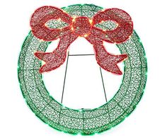 a lighted christmas wreath with red bows and lights on the front is shown against a white background