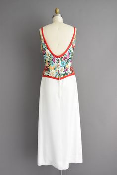 "Gorgeous vintage 1950s white full length bridesmaid cocktail party dress with an outstanding floral bodice that features a very flattering fitted bodice with bust darts, defined nipped waist and full length skirt. There is a back metal zipper for closure. ✂------ M E A S U R E M E N T S ------- Best Fit: Small Bust: 36\" Waist: 26\" Hips: 35.5\" Shoulders: undefined Total Length: 51.5\" tags/label: Pat Sandler Material: linen, sequins Condition: Near excellent vintage condition. Ready to wear. White Dress With Corset Back For Garden Party, 1950s Fitted Prom Dresses, White Maxi Dress With Boned Bodice For Formal Occasions, White Maxi Dress With Boned Bodice For Formal Events, White Formal Maxi Dress With Boned Bodice, White Fitted Empire Waist Maxi Dress, Vintage White Dress With Sweetheart Neckline, White Vintage Dress With Sweetheart Neckline, Fitted White Maxi Dress With Lined Bodice