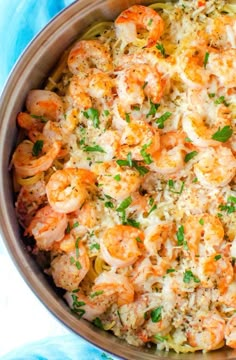 shrimp and rice casserole in a pot with parsley sprinkled on top