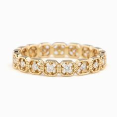 an 18k yellow gold and diamond ring, with four round diamonds on each side