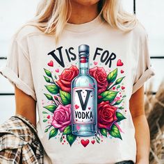 a woman wearing a t - shirt that says vise for vodka with roses on it