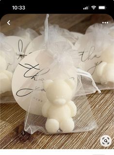 some white balls are wrapped in clear cellophane and sitting on a wooden table