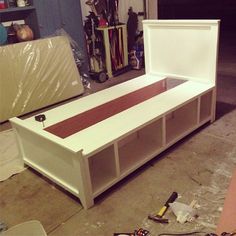 a white bed frame sitting in a garage