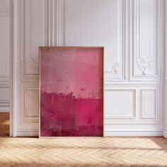 an empty room with a pink painting on the wall