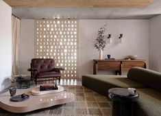 a living room filled with furniture and a large window covered in white circles on the wall