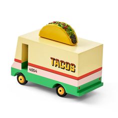 the taco truck is made out of cardboard and has a taco on top