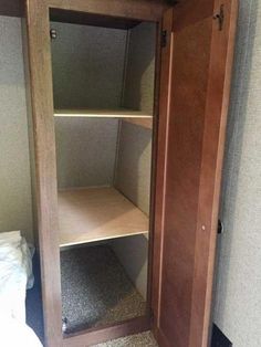 an empty closet in the corner of a room with carpet on the floor and walls