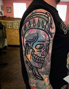 a man with a skull tattoo on his arm