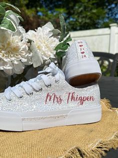 Hand Glittered unbranded canvas sneakers glittered in a gorgeous chunky white mix called *bungalow* with rose gold glitter personalization of your choice.  White glitter trim is optional.  Made to order. Personalization is added in rose gold glitter to include name on the outside of each sneaker and date down the back as shown. Please include custom info in the order notes. Should you desire different placement or options, please send us a message. We offer several personalization colors as well as rose gold sneakers. Check out our other options here: glitteritglam.etsy.com Glitter is high quality and heat set for minimal glitter loss and lasting quality, though, you may see glitter shedding the first time you wear/try on your shoes.  Although we aim to remove every loose piece of glitter Low-top Glitter Sneakers For Wedding, Bride Sneakers, Sparkle Sneakers, Bridal Parties Colors, Bridal Sneakers, Rose Gold Sneakers, Gold Sneakers, Glitter Girl, Glitter Wedding