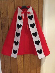 a red cape with black hearts on it