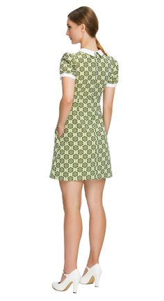 SEASON'S END SALE! LImited quantity left. Fitted sixties style, shades of navy blue, a-line dress; a versatile piece suitable for both work and play. This dress features a charming floral pattern in various shades of green, exuding a delightful retro vibe. The style features a white bib offset by a 4-button-detailed tab, slightly puffed short sleeves, and functional side pockets, adding a touch of timeless elegance and practicality to the ensemble. To suit your style, this dress is also availabl Mod Spring Workwear Dresses, Retro A-line Mini Dress For Work, Green Knee-length Mod Dress, Green Mod Knee-length Dress, Mod Mini Dress With Short Sleeves, Green Cotton Mini Dress For Work, Retro Green A-line Mini Dress, Mod Green A-line Dress, Green Mod A-line Dress